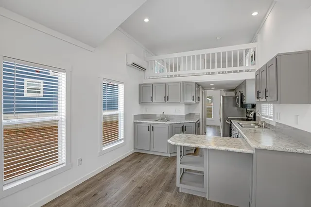a kitchen with sink cabinets and wooden floor