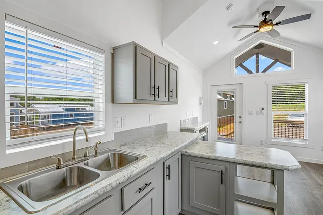 a kitchen with a sink a counter space cabinets and appliances