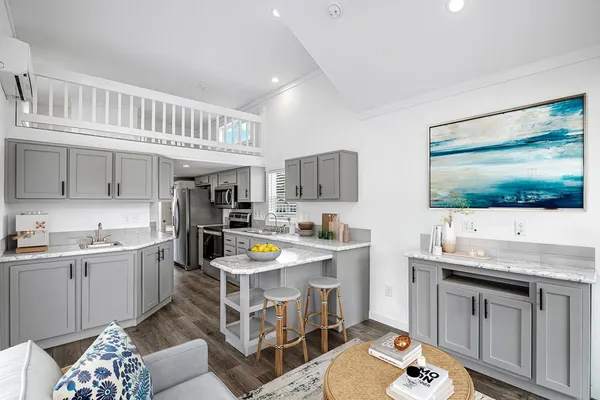 a kitchen with a sink and wooden floor