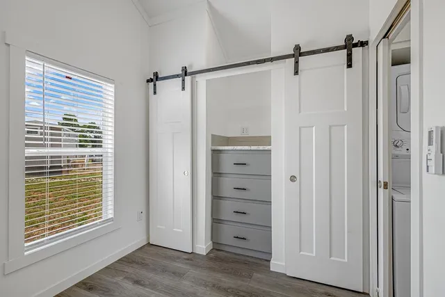a view of walk in closet with empty racks