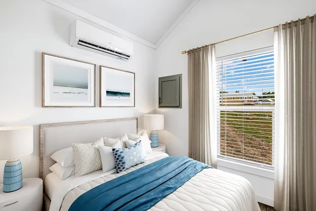 a bedroom with a large bed and a window