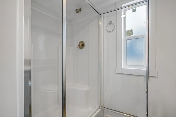 a bathroom with a glass shower door