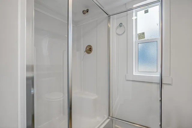 a bathroom with a glass shower door