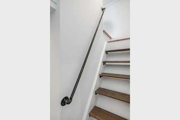 a view of staircase with white walls