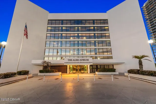 a dining room with lots of wooden furniture and a chandelier