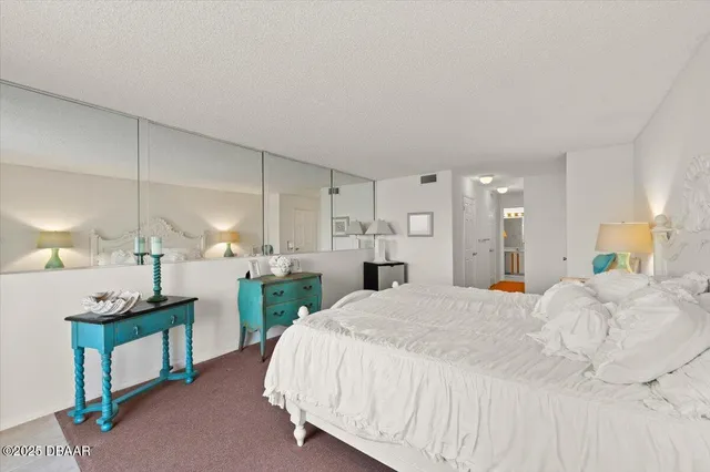 a spacious bathroom with a toilet a sink and mirror