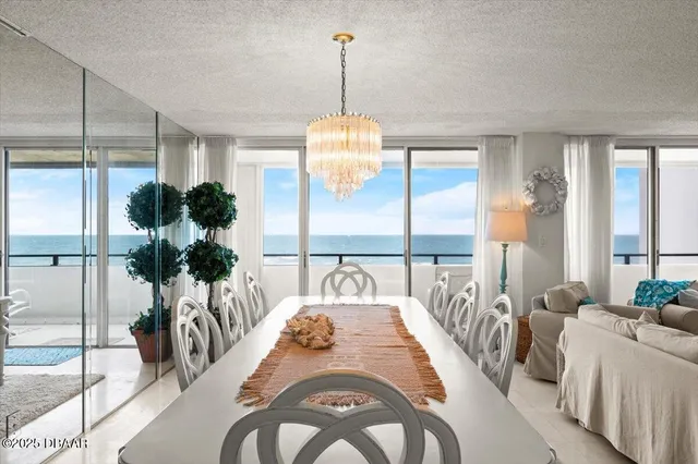 a living room with furniture a flat screen tv and a large window