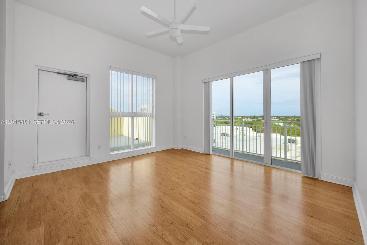 7275 Southwest 90th Street, Unit C719 Miami, FL 33156 - Photo 12 of 25 an empty room with wooden floor and windows