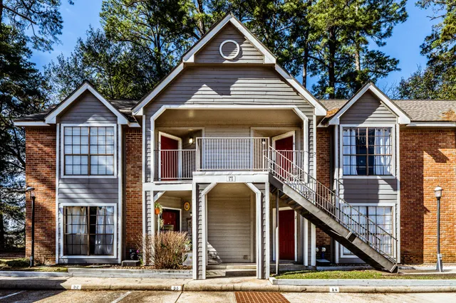 a front view of residential houses with yard