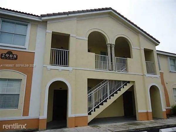 a view of a blue house with large windows