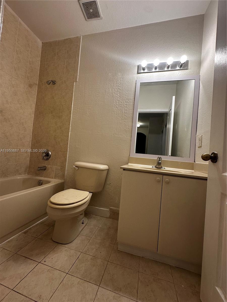 2903 Southeast 17th Avenue, Unit 209 Homestead, FL 33035 - Photo 16 of 30 a bathroom with a toilet a sink and bathtub