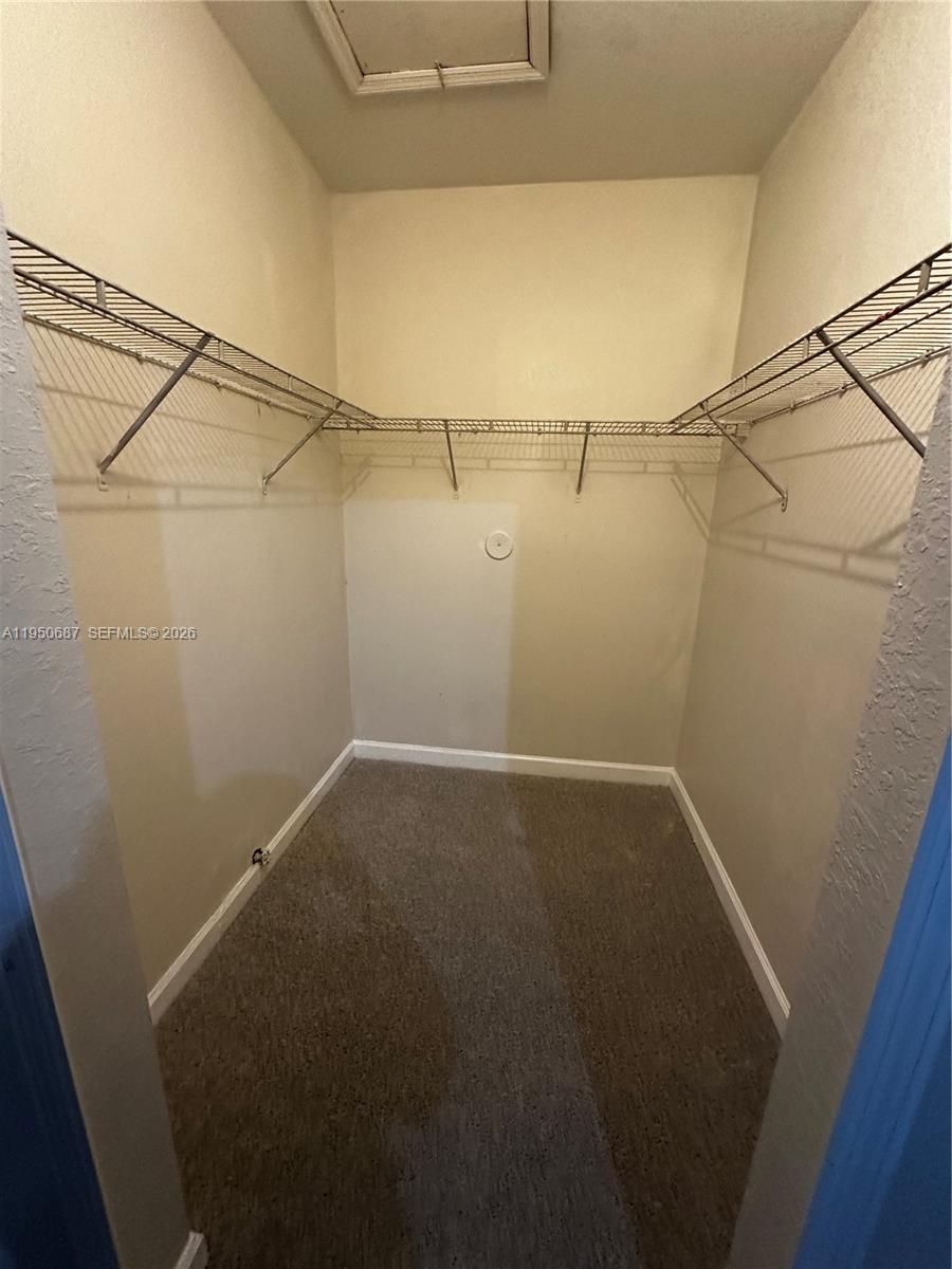 2903 Southeast 17th Avenue, Unit 209 Homestead, FL 33035 - Photo 17 of 30 a view of a room with racks on the wall