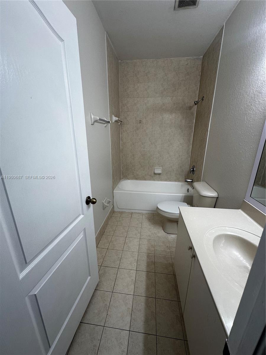 2903 Southeast 17th Avenue, Unit 209 Homestead, FL 33035 - Photo 19 of 30 a bathroom with a sink a toilet and a tub