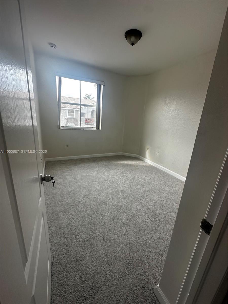 2903 Southeast 17th Avenue, Unit 209 Homestead, FL 33035 - Photo 20 of 30 a view of an empty room with a window
