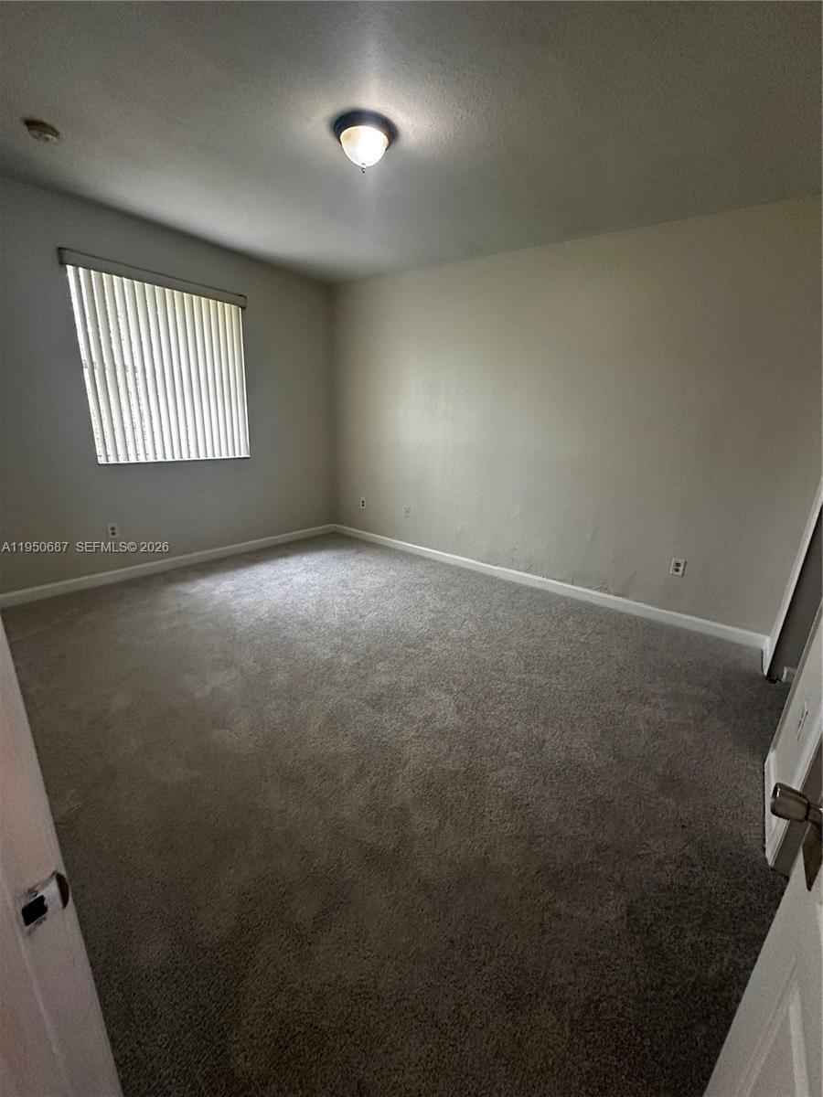 2903 Southeast 17th Avenue, Unit 209 Homestead, FL 33035 - Photo 28 of 30 an empty room with windows