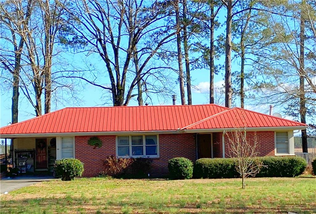 390 Warren Road Northeast Rome, GA 30165 - Photo 1 of 1 a view of a house with backyard and sitting area