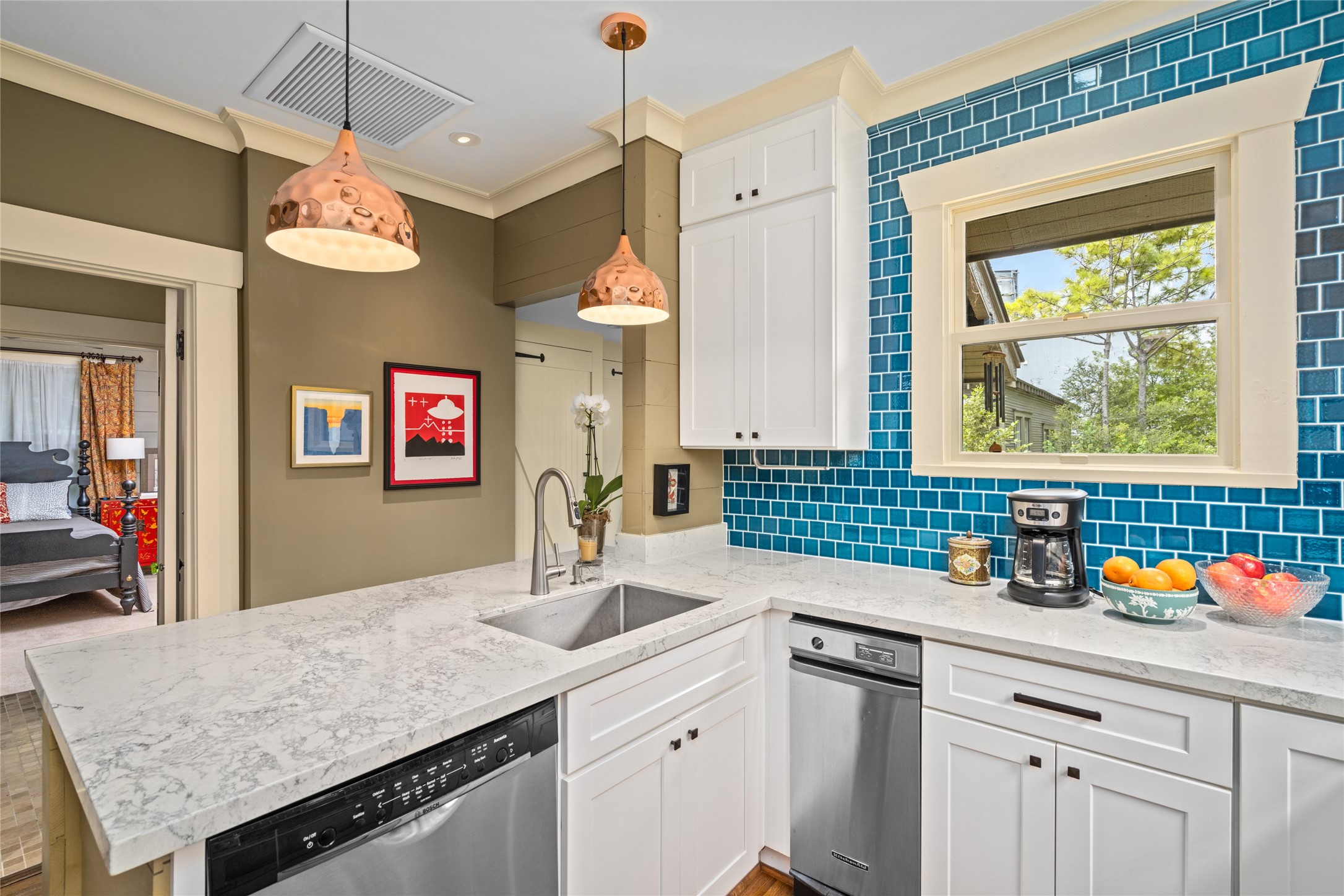 4502 Stanford Street Houston, TX 77006 - Photo 19 of 39 a kitchen with a sink dishwasher a stove a dining table and chairs with wooden floor