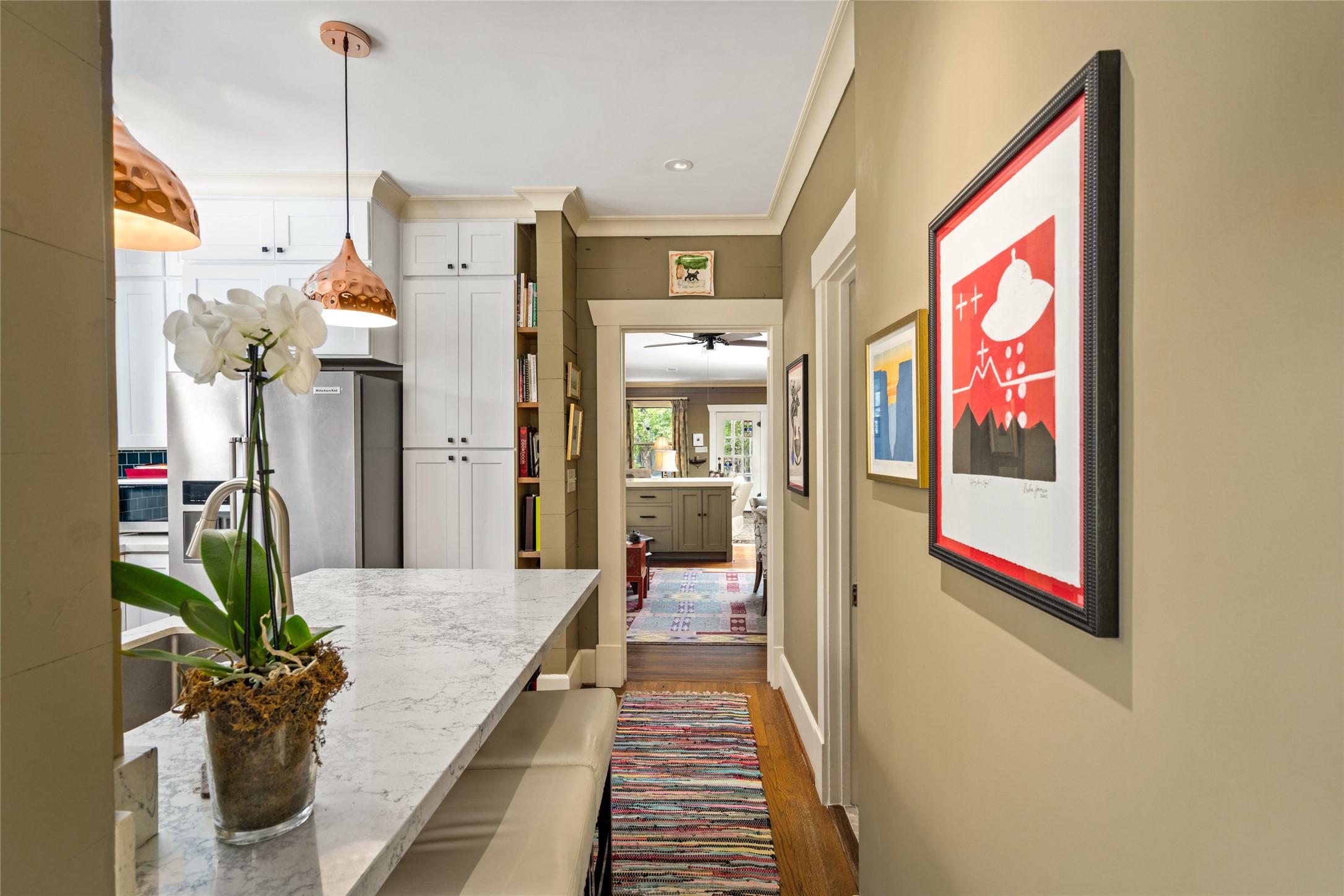 4502 Stanford Street Houston, TX 77006 - Photo 20 of 39 a hallway with beautiful frames and flower vase