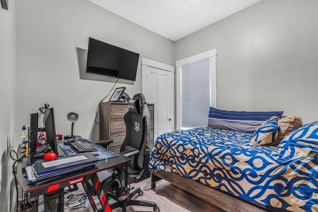 145 Maple Street Danvers, MA 01923 - Photo 11 of 27 a bedroom with a bed and a flat screen tv