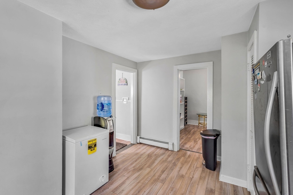 145 Maple Street Danvers, MA 01923 - Photo 16 of 27 a view of kitchen filled with stainless steel appliances wooden floor and a window