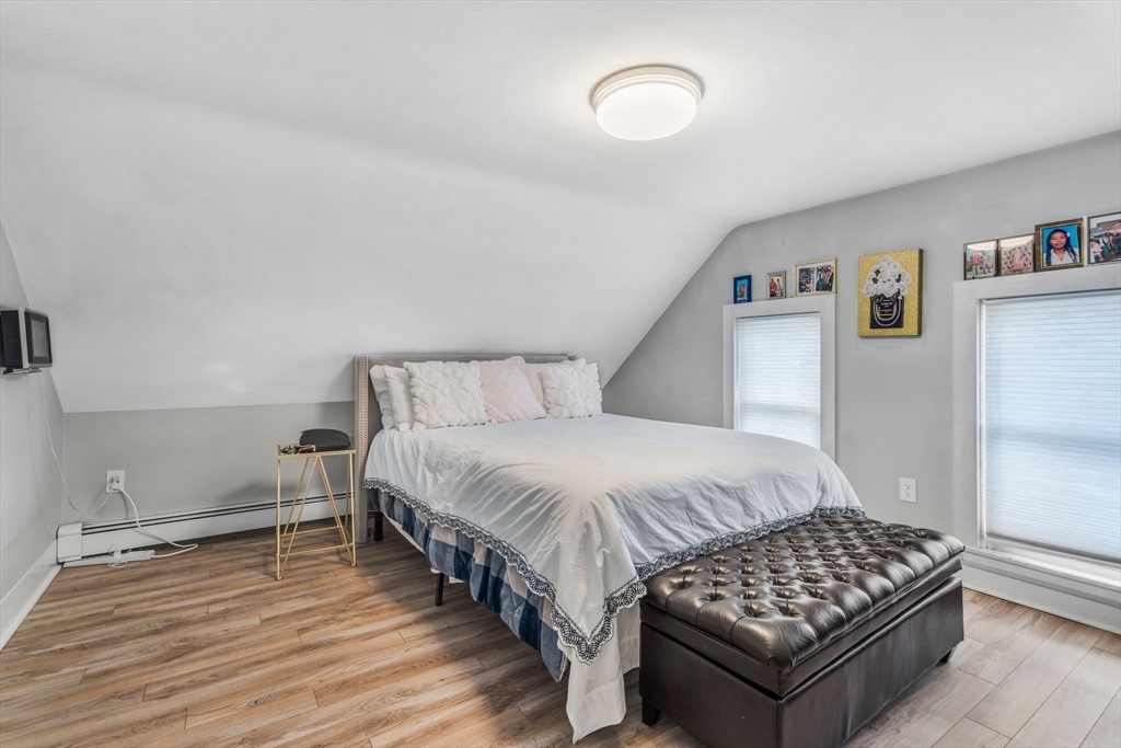 145 Maple Street Danvers, MA 01923 - Photo 20 of 27 a bedroom with a bed and wooden floor