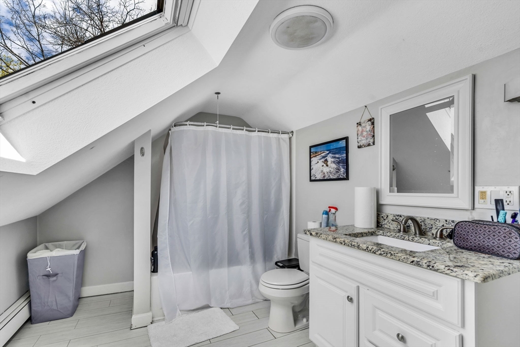 145 Maple Street Danvers, MA 01923 - Photo 22 of 27 a bathroom with a granite countertop sink mirror vanity and toilet