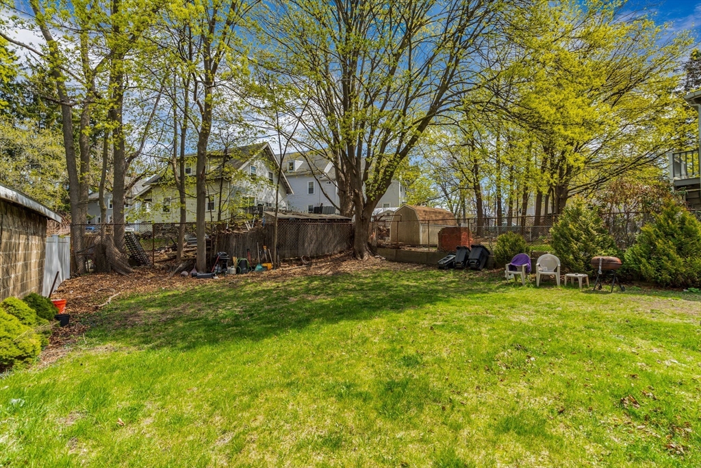 145 Maple Street Danvers, MA 01923 - Photo 3 of 27 a front view of a house with a yard and trees