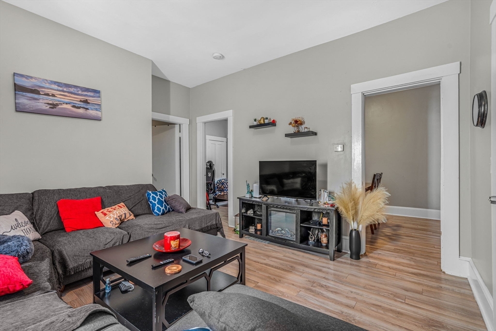 145 Maple Street Danvers, MA 01923 - Photo 5 of 27 a living room with furniture and a flat screen tv with wooden floor