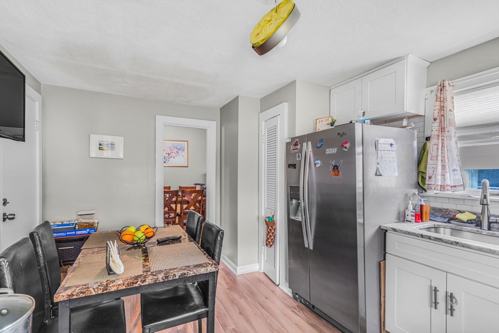 145 Maple Street Danvers, MA 01923 - Photo 9 of 27 a kitchen with stainless steel appliances granite countertop a refrigerator and a sink