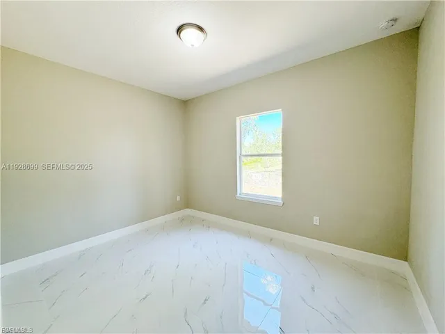 an empty room with a empty space and a window