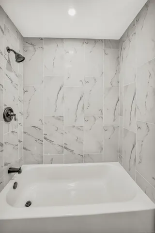 a bathroom with a bathtub and a shower