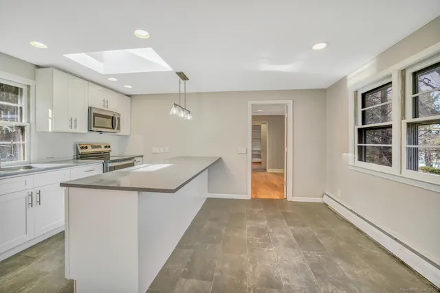 a kitchen with granite countertop a sink and cabinets