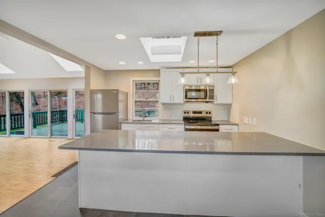a kitchen with granite countertop a stove and a sink