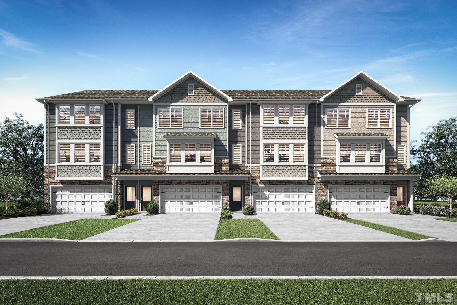 a front view of residential houses with yard