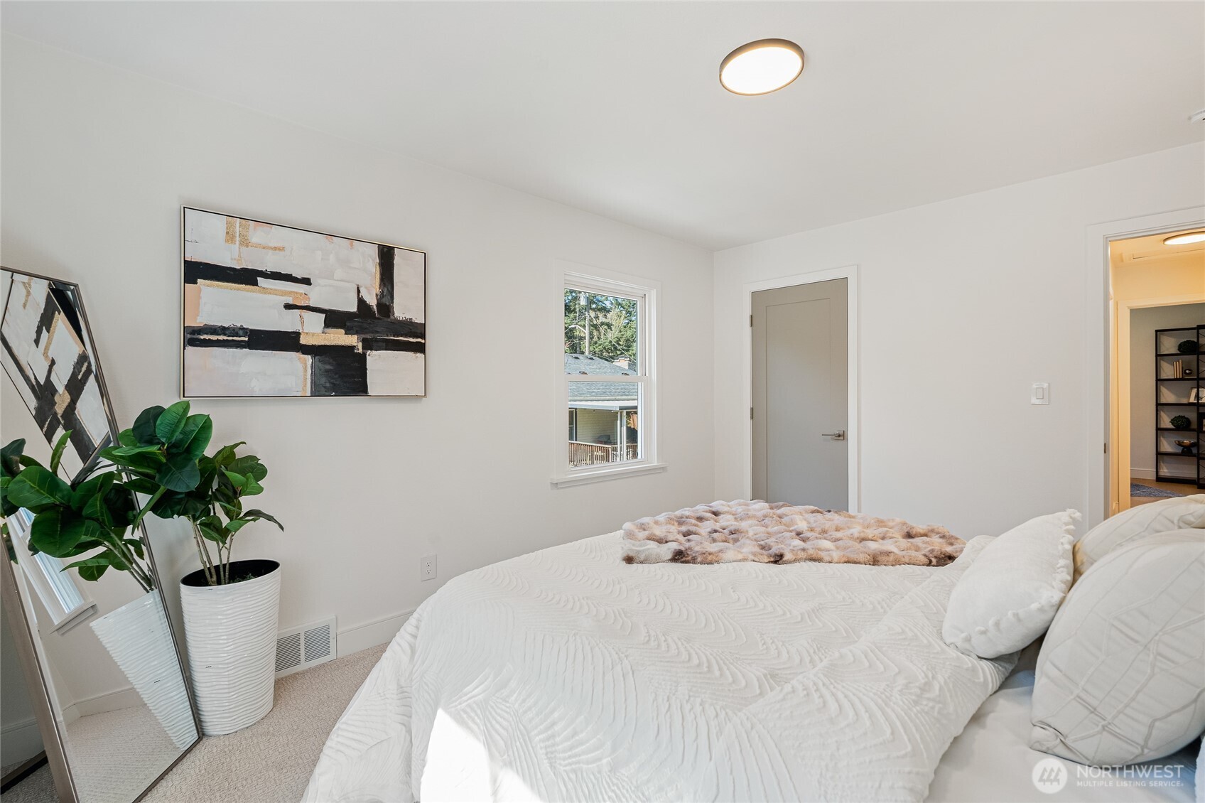 1710 Northeast 104th Street Seattle, WA 98125 - Photo 22 of 40 a bedroom with a bed and a potted plant