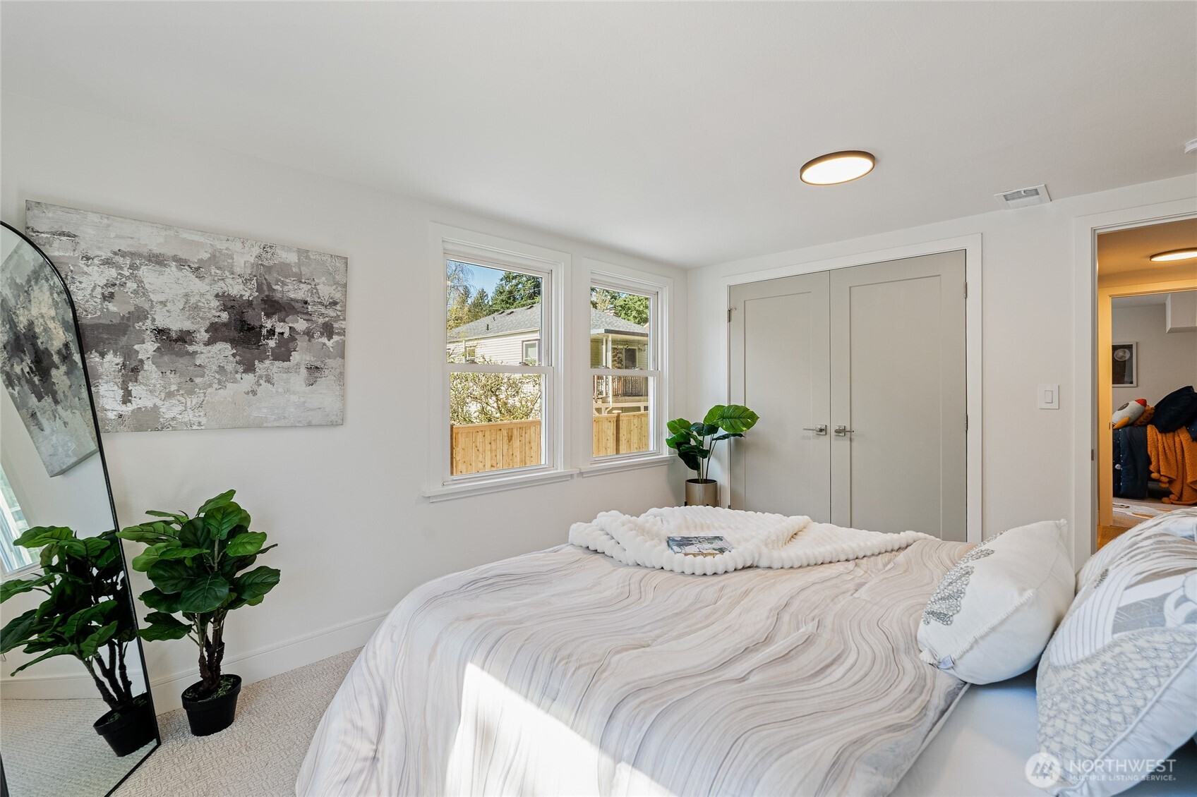 1710 Northeast 104th Street Seattle, WA 98125 - Photo 27 of 40 a bedroom with a bed and a potted plant