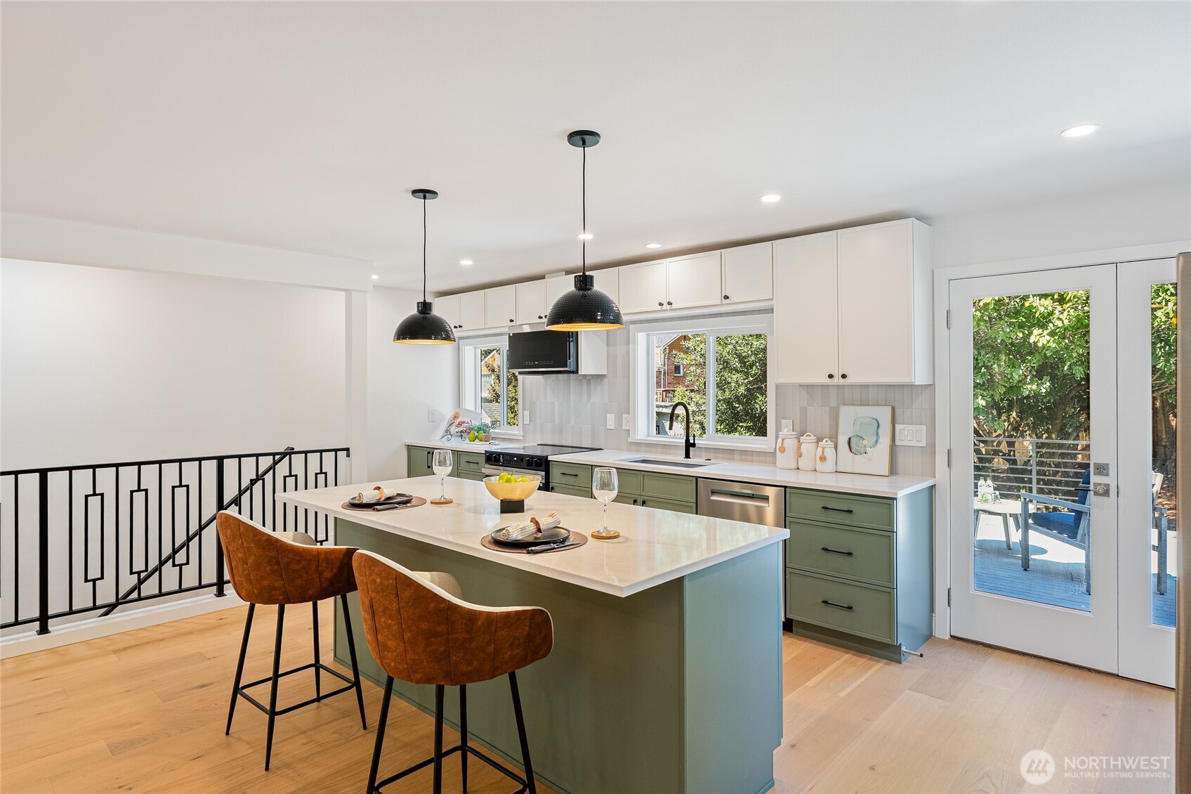 1710 Northeast 104th Street Seattle, WA 98125 - Photo 6 of 40 a kitchen with a dining table chairs and white cabinets