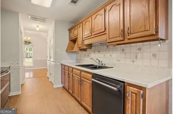 a kitchen with stainless steel appliances granite countertop a sink stove and cabinets