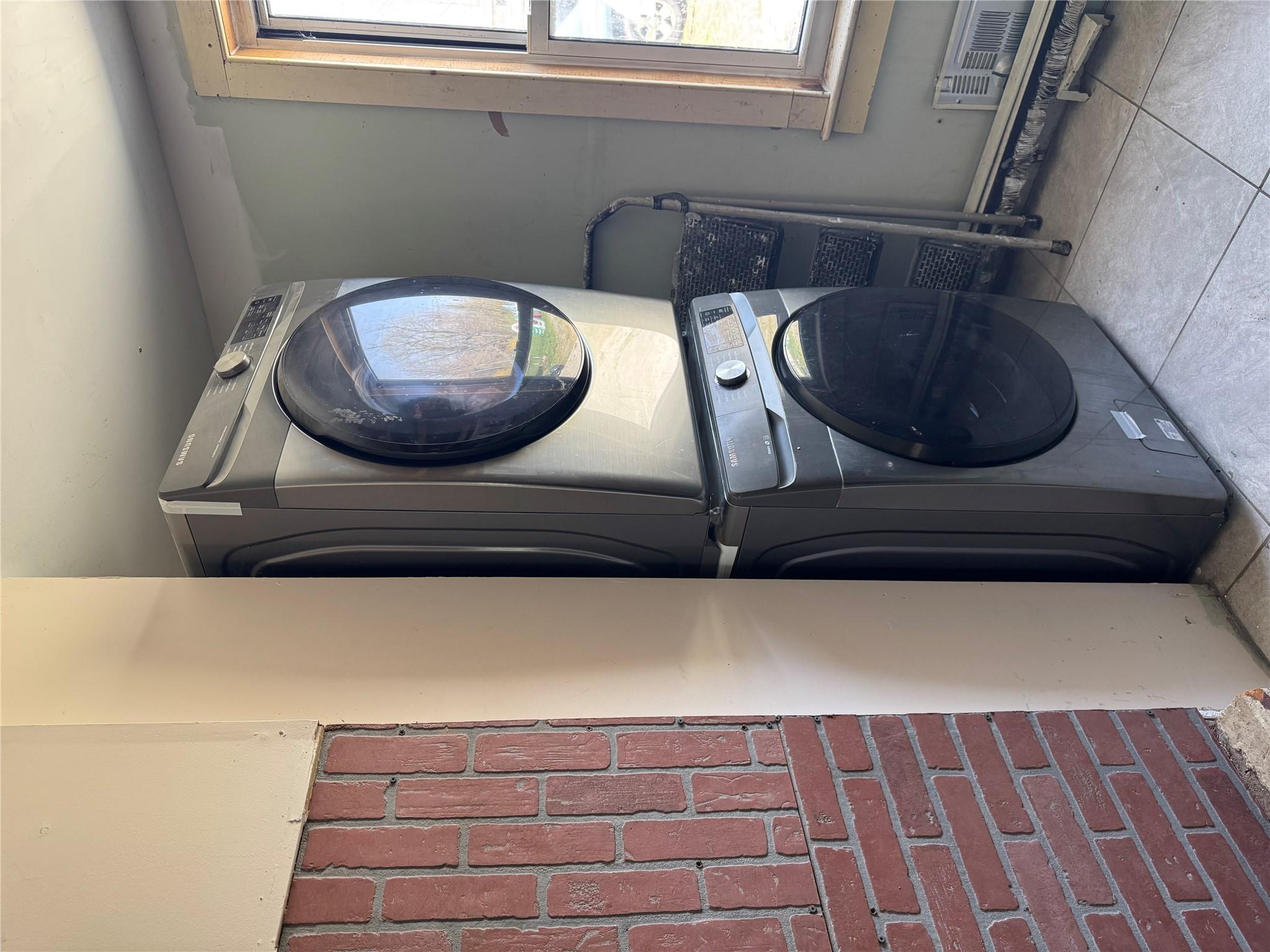 50 Hamilton Road Bloomingburg, NY 12721 - Photo 16 of 33 Laundry room featuring visible vents, stacked washer / dryer, tile patterned floors, and laundry area