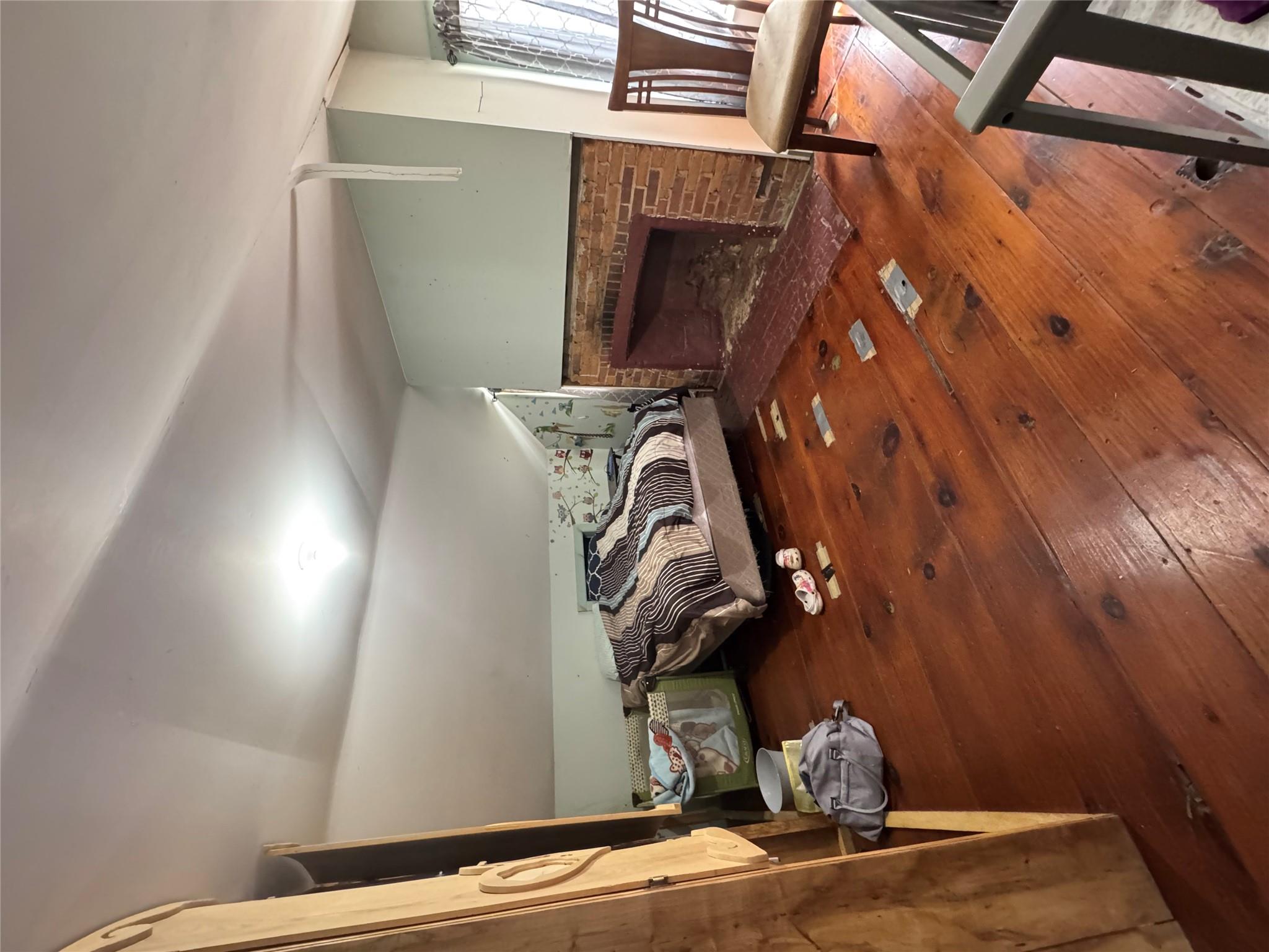 50 Hamilton Road Bloomingburg, NY 12721 - Photo 23 of 33 Bedroom featuring vaulted ceiling, a brick fireplace, and hardwood / wood-style floors
