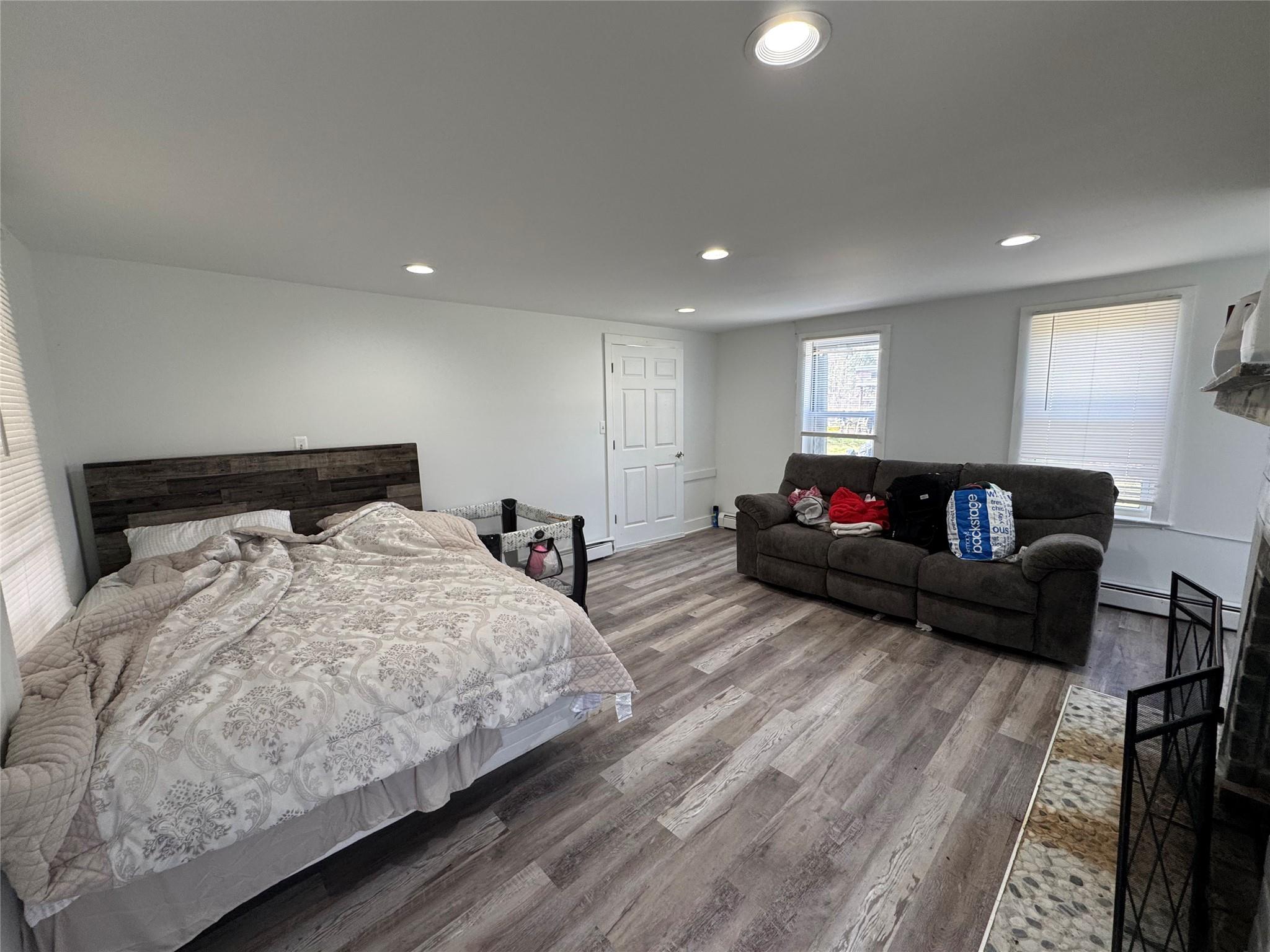 50 Hamilton Road Bloomingburg, NY 12721 - Photo 5 of 33 Bedroom with recessed lighting, wood finished floors, baseboards, and a baseboard heating unit