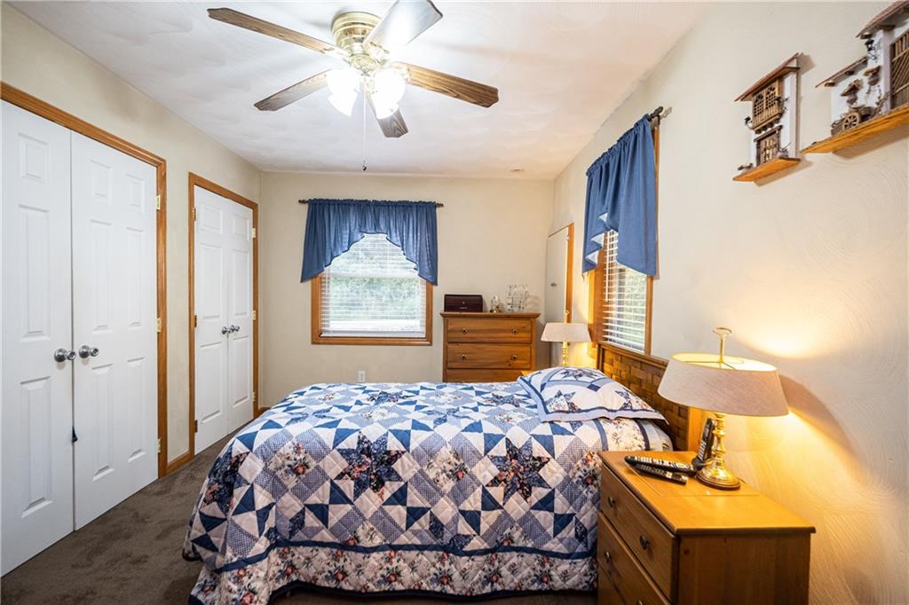 6050 Poketa Road Verona, PA 15147 - Photo 13 of 25 Master bedroom offers double closets, high ceilings, ceiling fan and plenty of natural lighting.