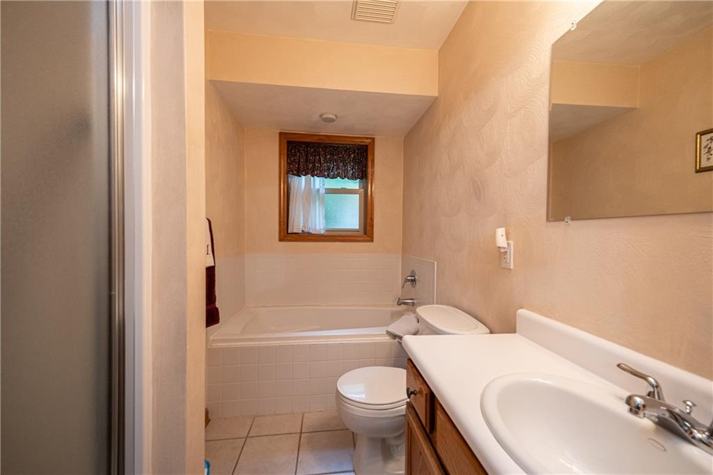 6050 Poketa Road Verona, PA 15147 - Photo 15 of 25 Full bath with separate shower and tub and a large vanity with ample storage.