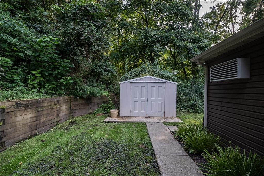 6050 Poketa Road Verona, PA 15147 - Photo 24 of 25 Cement sidewalk and landscaping leads to the convenient storage shed.