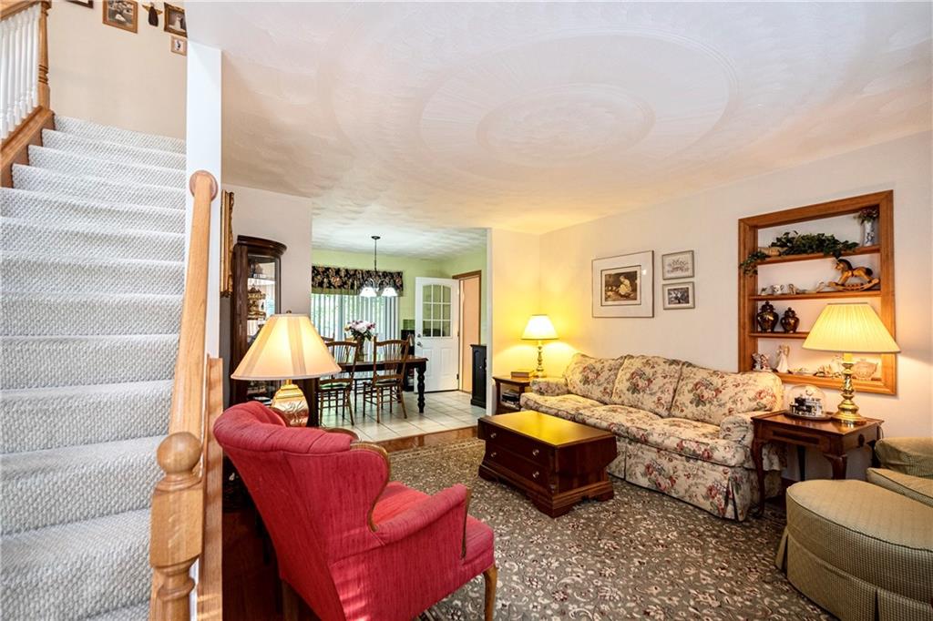 6050 Poketa Road Verona, PA 15147 - Photo 6 of 25 The living room offers gleaming hardwood floors and a wide open entryway that guides you into the dining space.