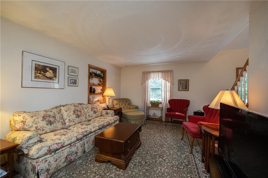 6050 Poketa Road Verona, PA 15147 - Photo 7 of 25 Spacious living and character with a quaint built-in shelf to display family photos and prized possessions.