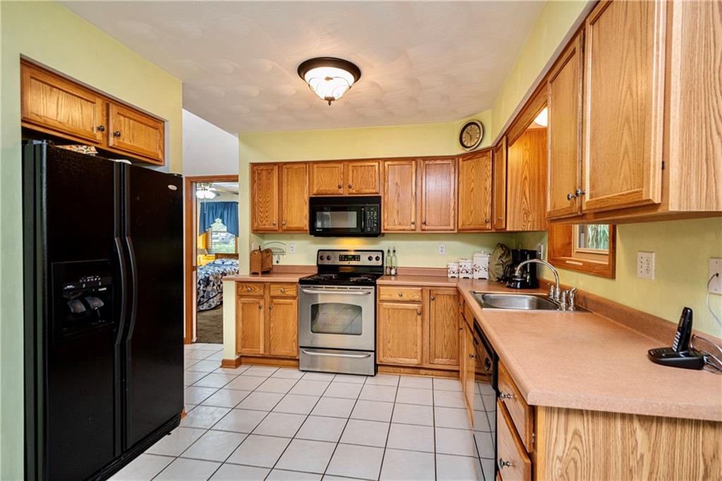6050 Poketa Road Verona, PA 15147 - Photo 8 of 25 This kitchen is well equipped with an abundance of cabinetry and counter space and includes refrigerator, oven, microwave, dishwasher and disposal.