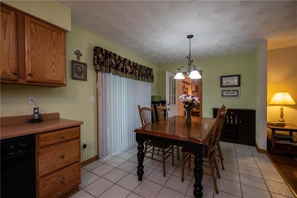 6050 Poketa Road Verona, PA 15147 - Photo 9 of 25 Dining room and kitchen are adjacent, making family meals and entertaining guests a breeze.