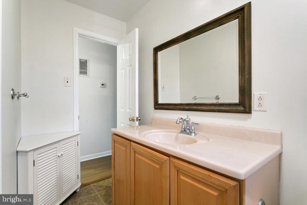 9 Oberlin Road Pennsville, NJ 08070 - Photo 11 of 23 a bathroom with a sink vanity and a mirror