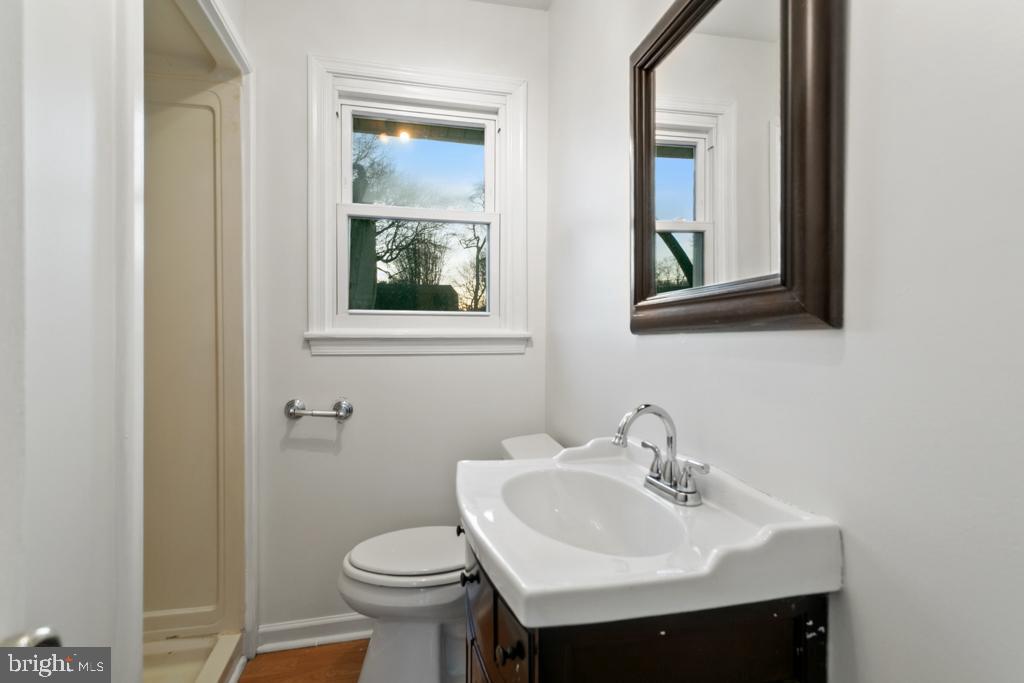 9 Oberlin Road Pennsville, NJ 08070 - Photo 14 of 23 a bathroom with a sink toilet and a mirror
